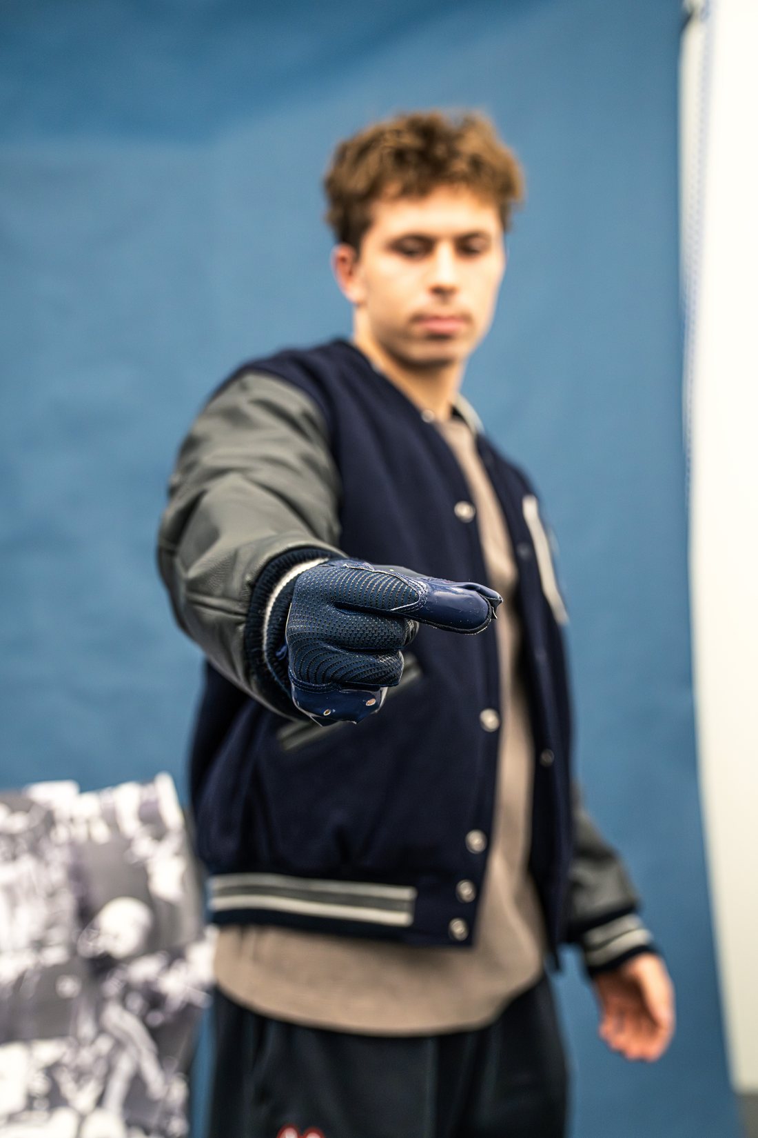 Cooper in the photo studio pinching the air in a Nike glove